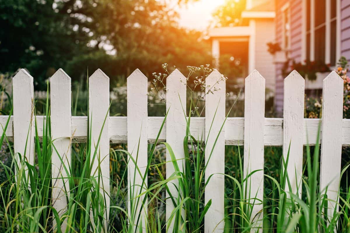 White wooden fence in suburban neighborhood

