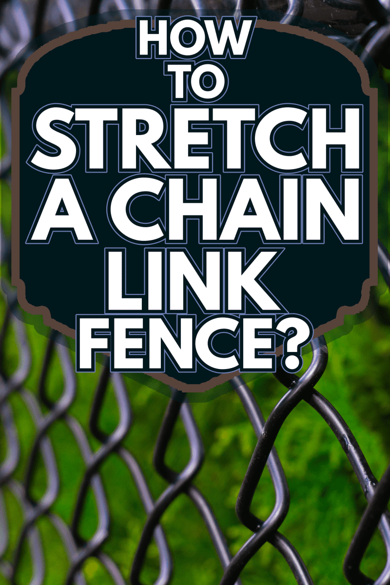 A black chain link fence photographed from a creative perspective to give the image depth - How To Stretch A Chain Link Fence