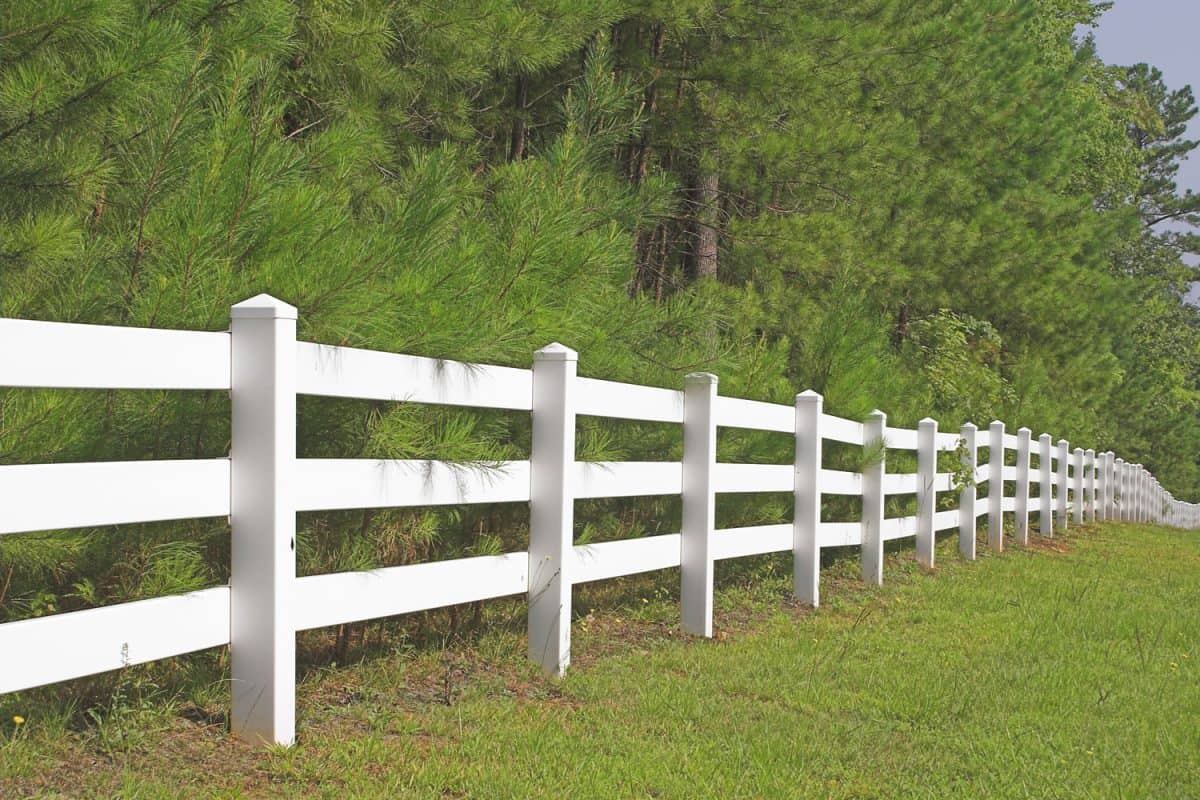 A long white fence of a farm