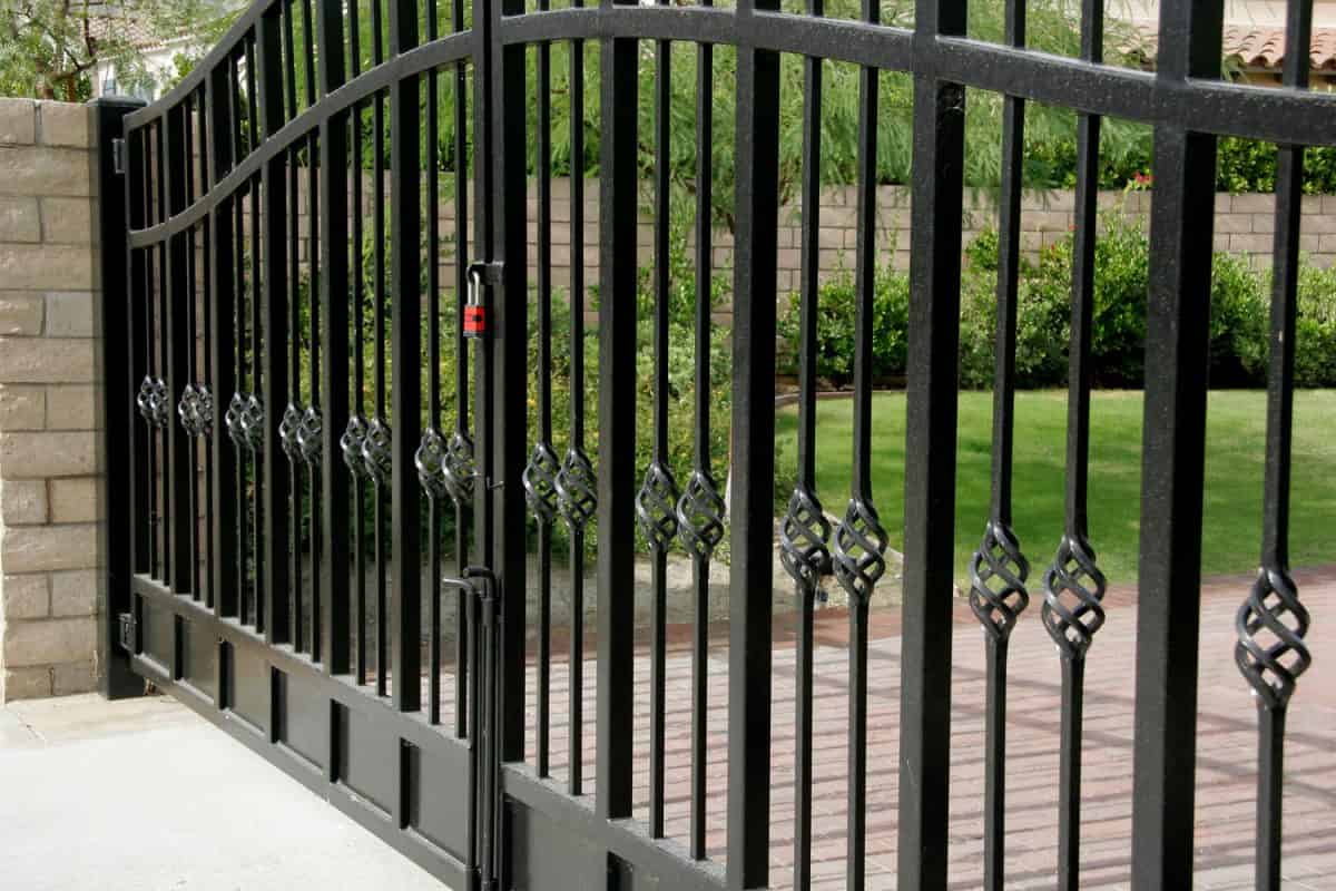 A wrought iron gate with a padlock