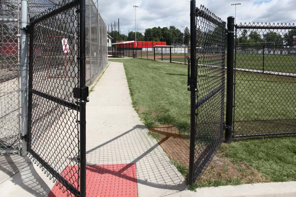 Black powder coated chain link fence at a baseball field