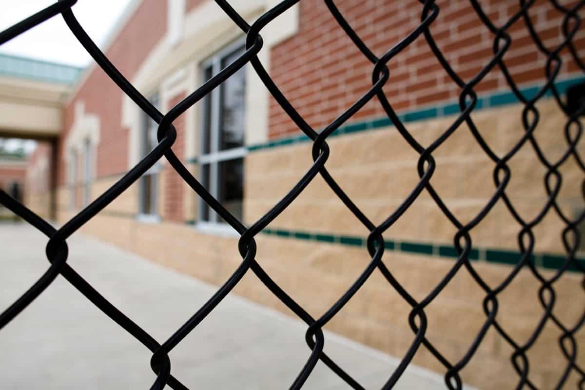 Chain link fence and school building