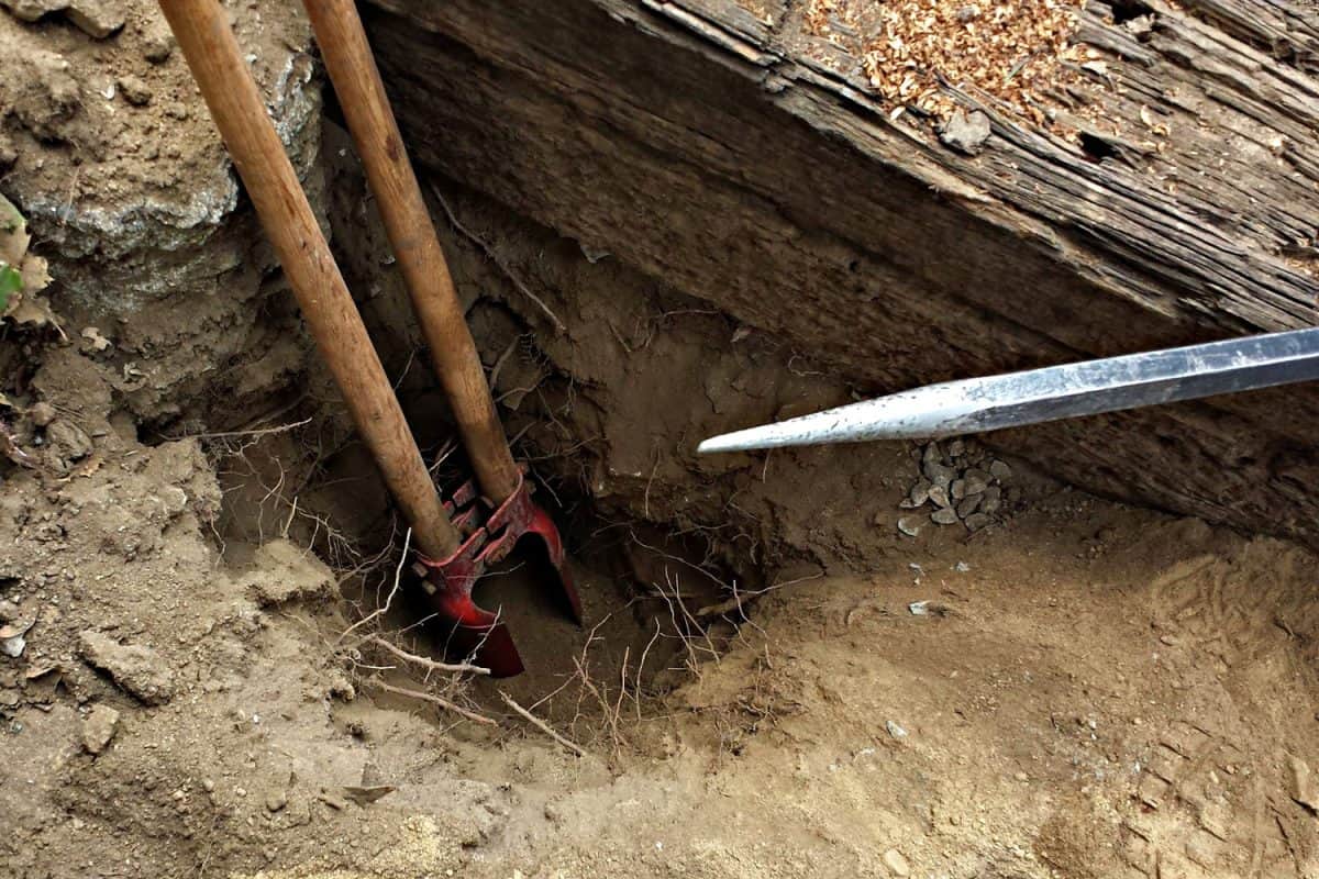 Digging a hole for a fence using a hole digger