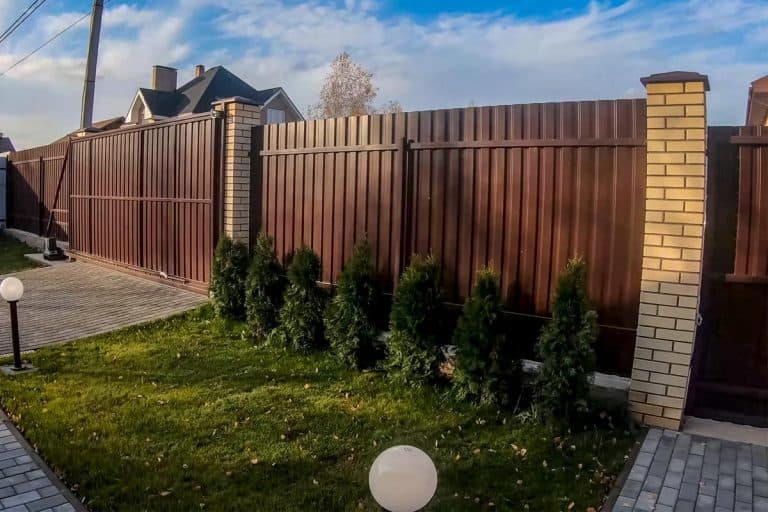 Fence and gate made of brown corrugated metal, How to Frame A Corrugated Metal Fence