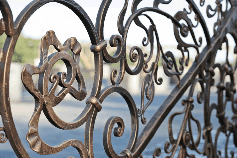Forged patterned fence in perspective. What's The Best Paint For A Wrought Iron Fence
