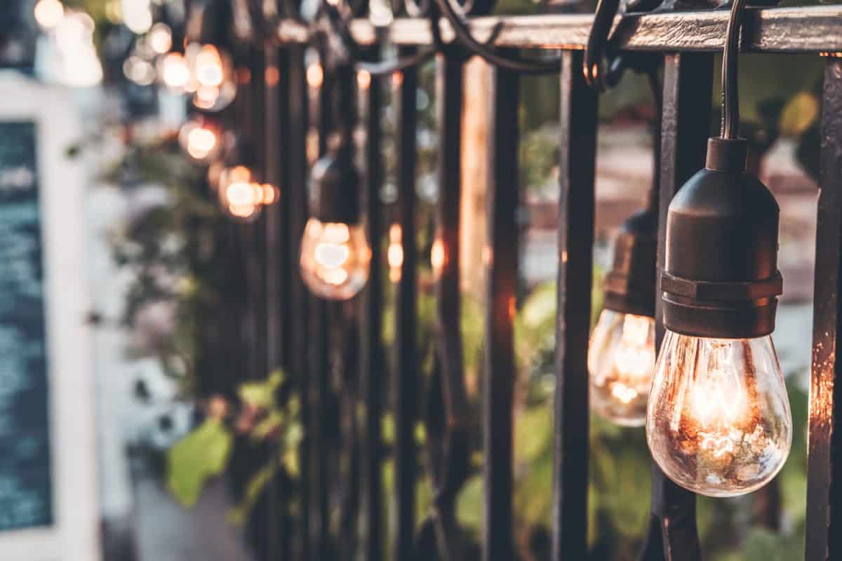 Hanging lights on wrought iron fences