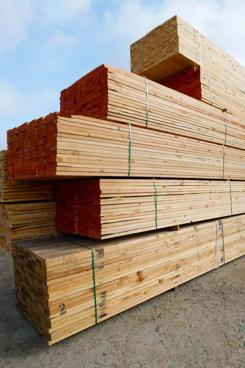 Huge bundles of pressure treated wood at stockpile