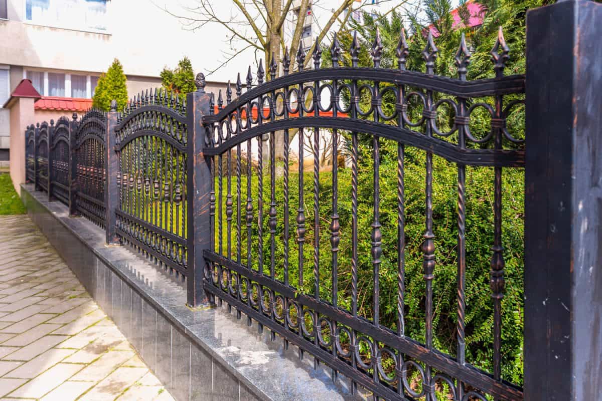 Huge reinforces wrought iron fence for a park