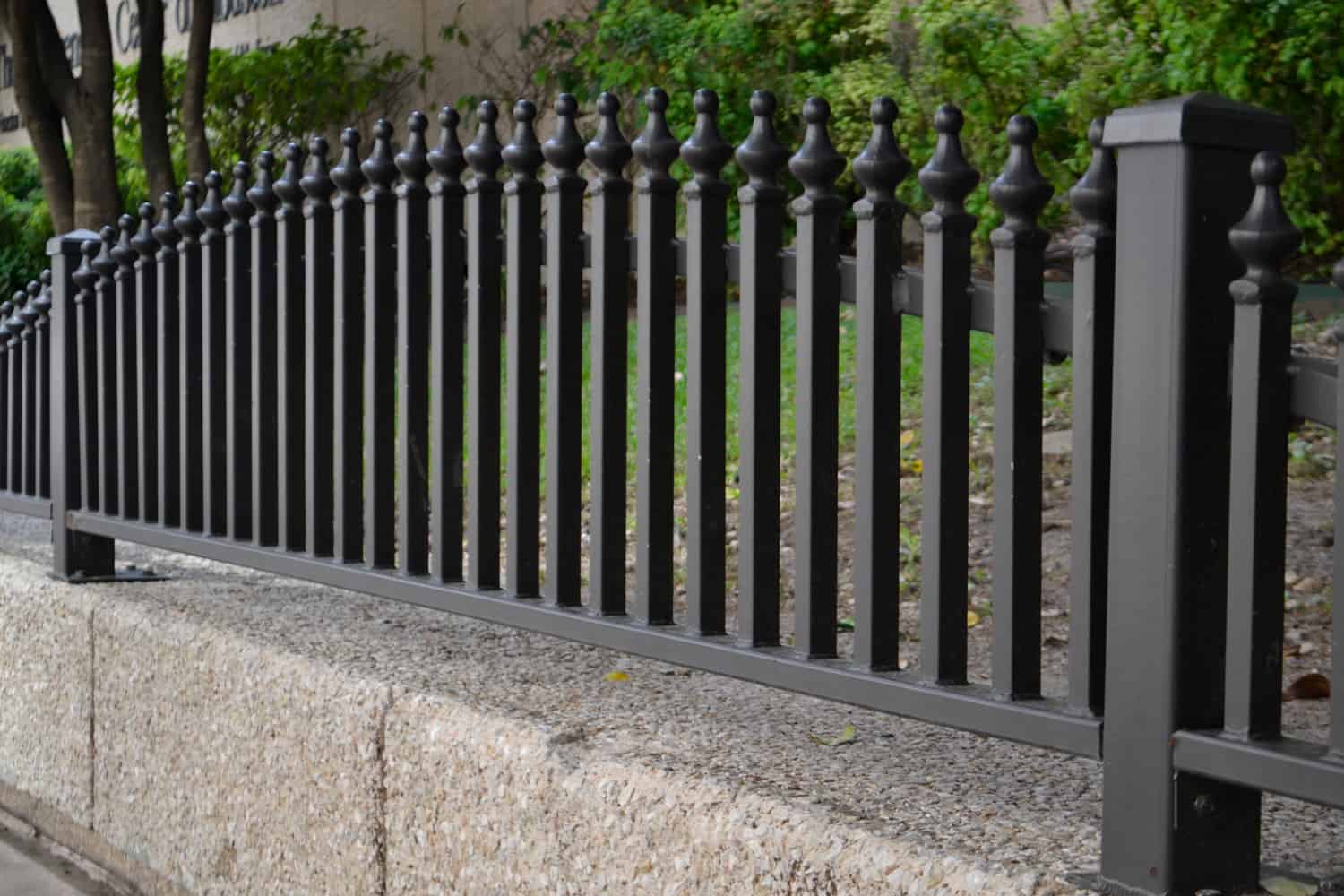 Iron Fence Over A Concrete Wall