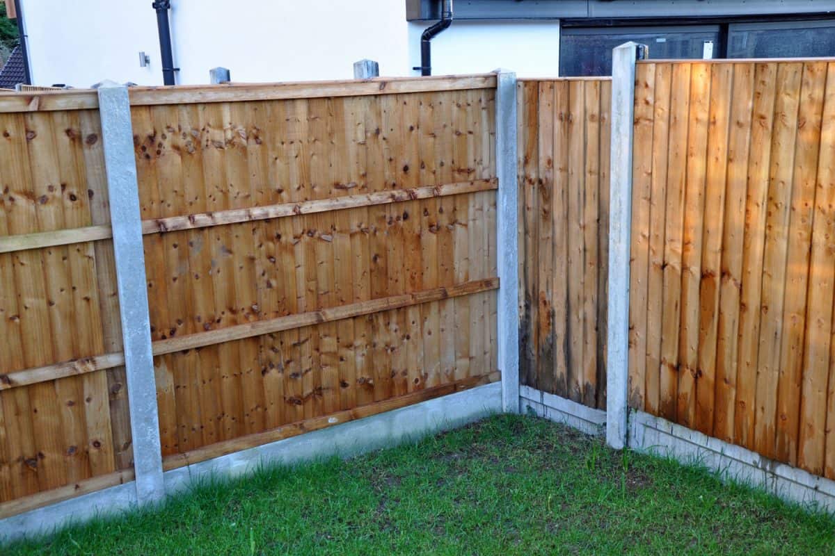 Pressure treated wood with concrete fence posts