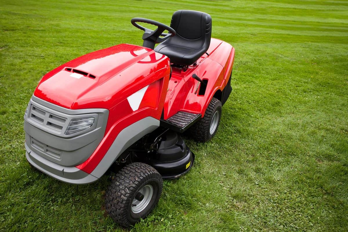 Red riding mower parked on the grass
