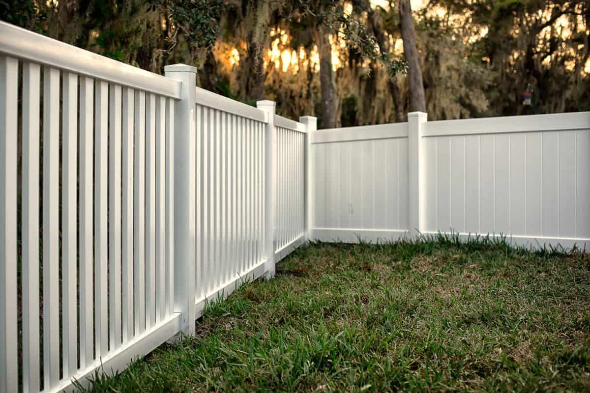 Small white picket fence painted in gloss white