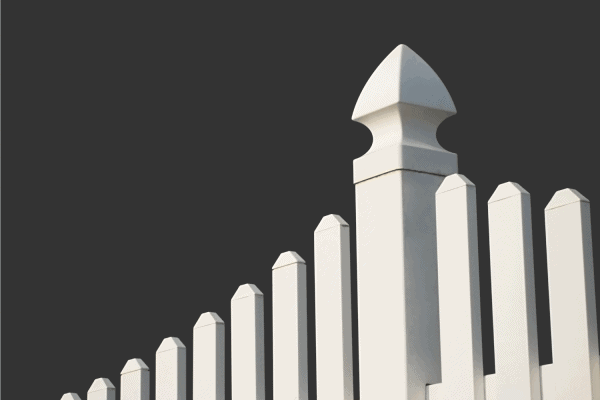 White picket fence with dark background.