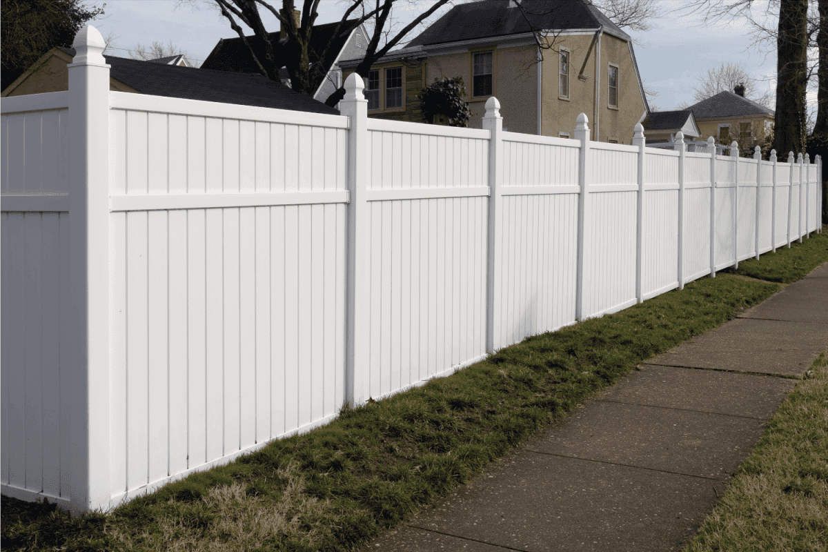 White vinyl fence in residential neighborhood.