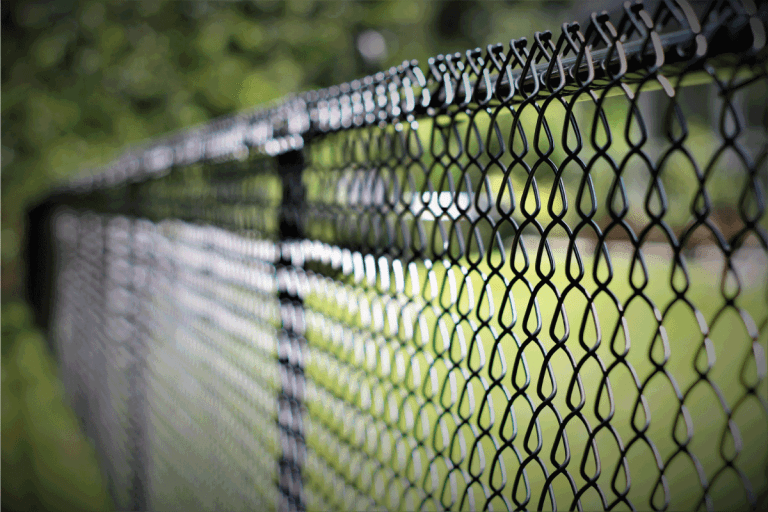 black chain link fence with fading focus and vignette. Are Chain Link Fences Good For Dogs