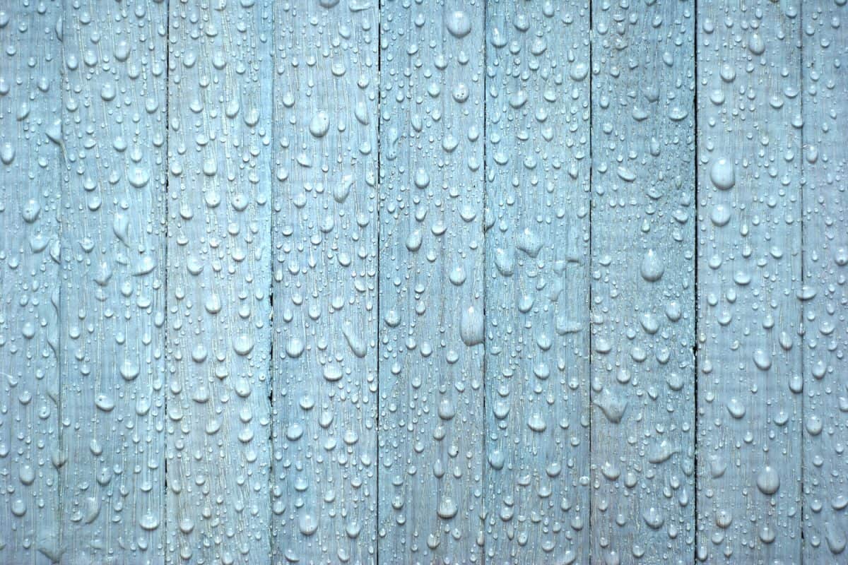 blue wooden background with rain drops
