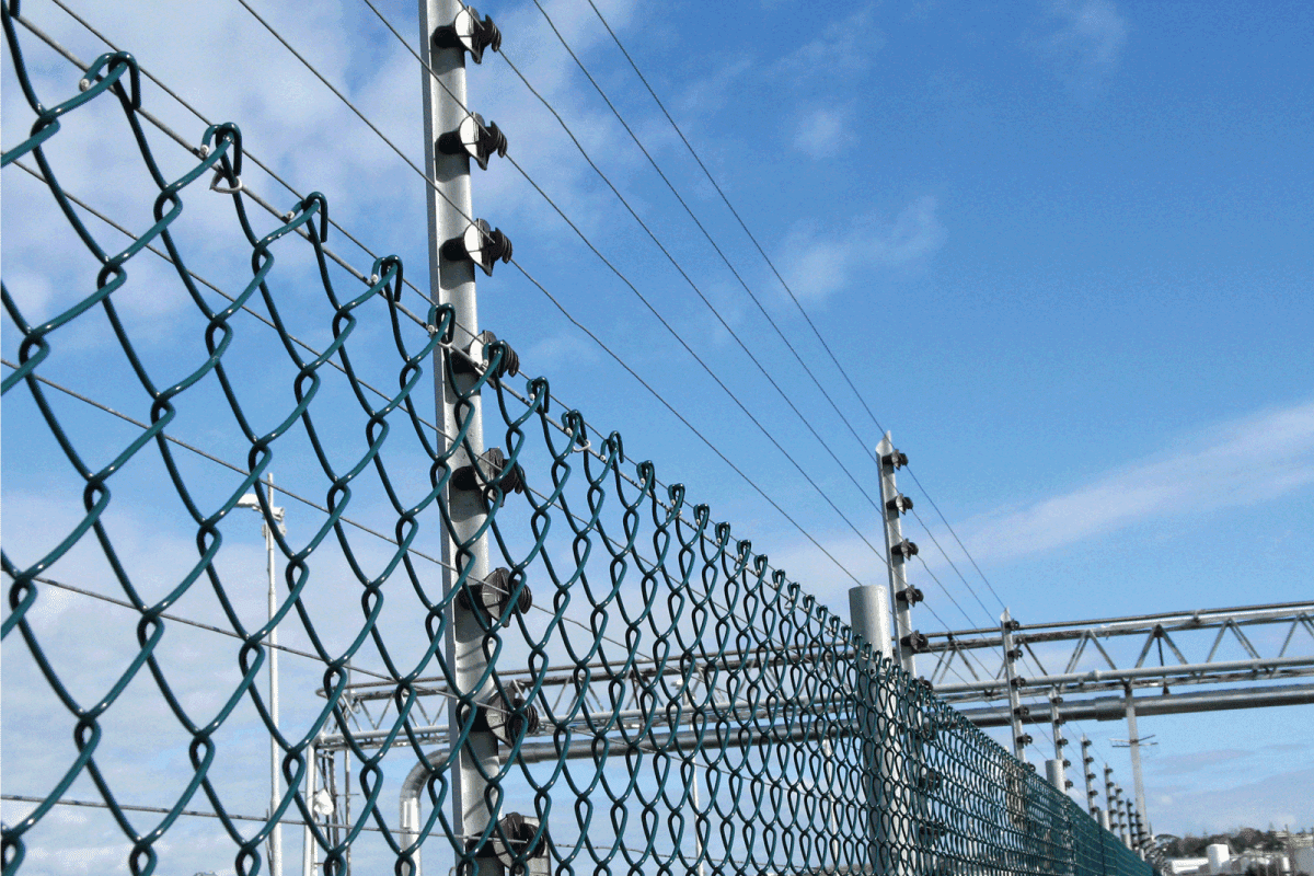 electric fence with the blue sky as the background. Can You Electrify A Chain Link Fence [And How To]