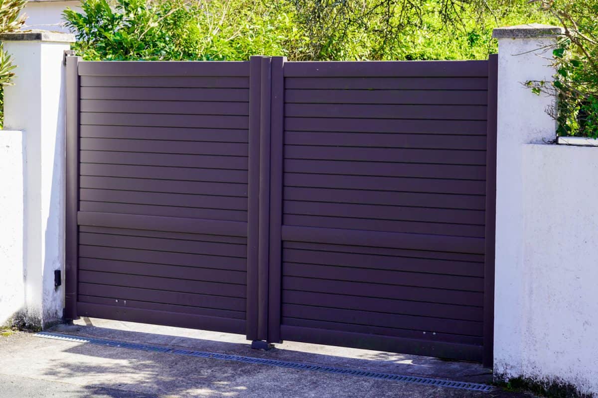 Aluminum black door dark gray metal gate of house steel portal of suburb access home
