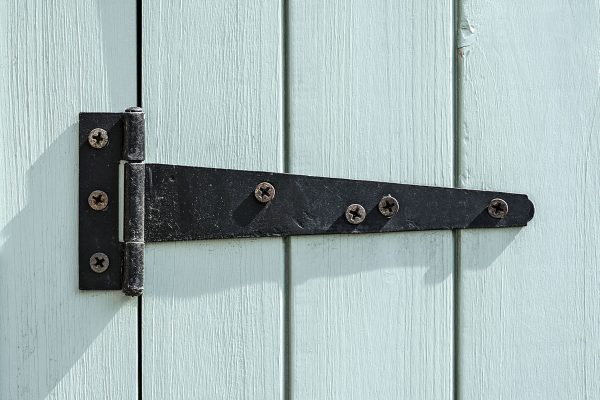 Black door hinge screwed to a bright painted wooden door, How Far Apart Should Gate Hinges Be?