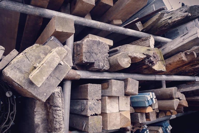A fence posts and wooden beams at a salvage yard, Can You Reuse Wooden Fence Posts?