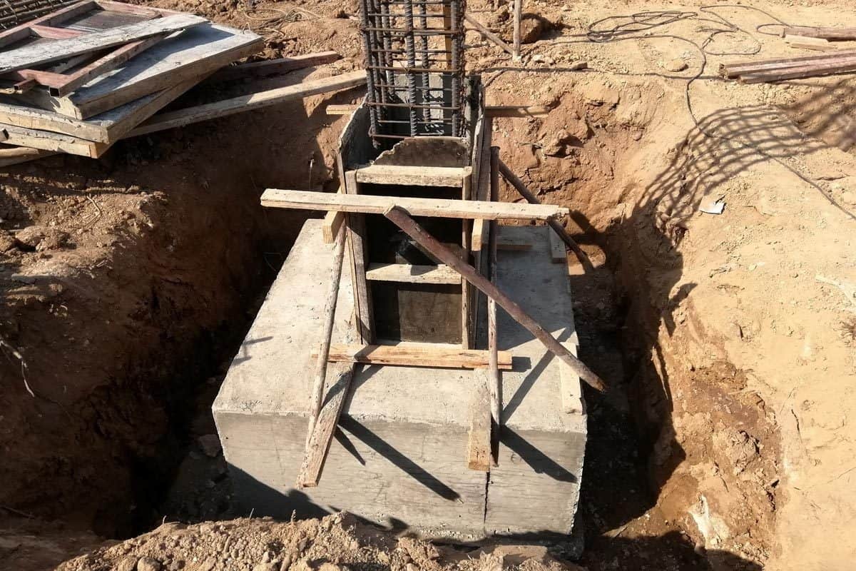 Hole for foundation pole concrete footings and reinforcing rod