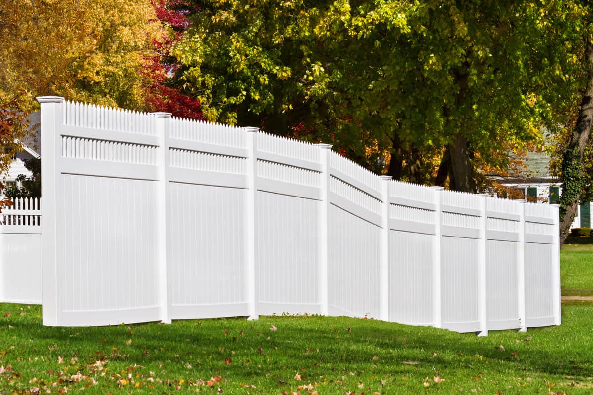 New white vinyl fence in yard