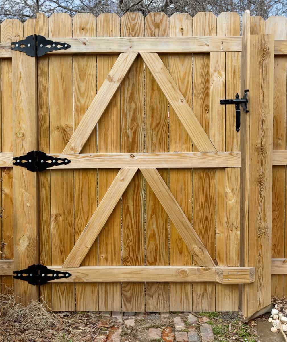 Newly built residential backyard wooden gate with hinges. 