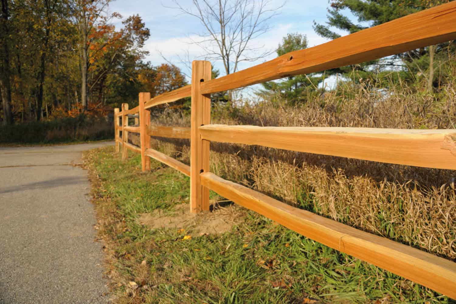 wooden split rail fence under the afternoon sun
